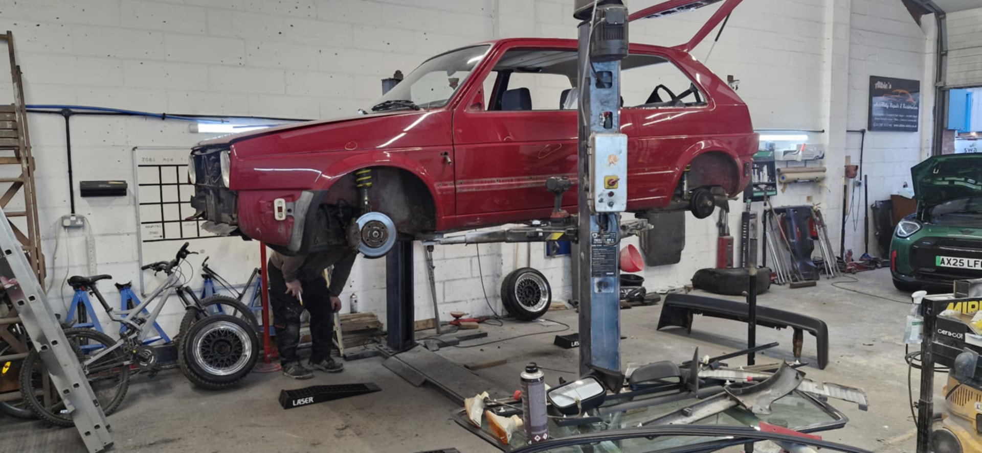 Albie's workshop with a vehicle raised on the lift
