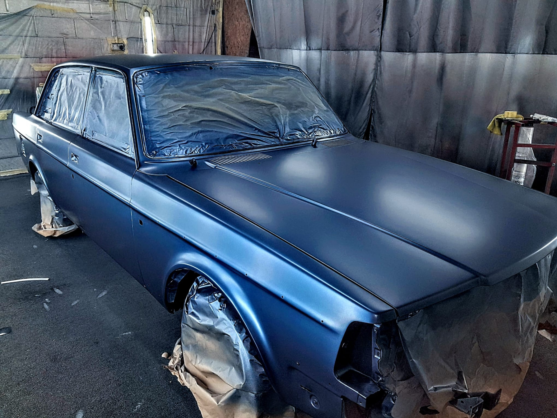 Classic car in fresh paint inside the spray booth