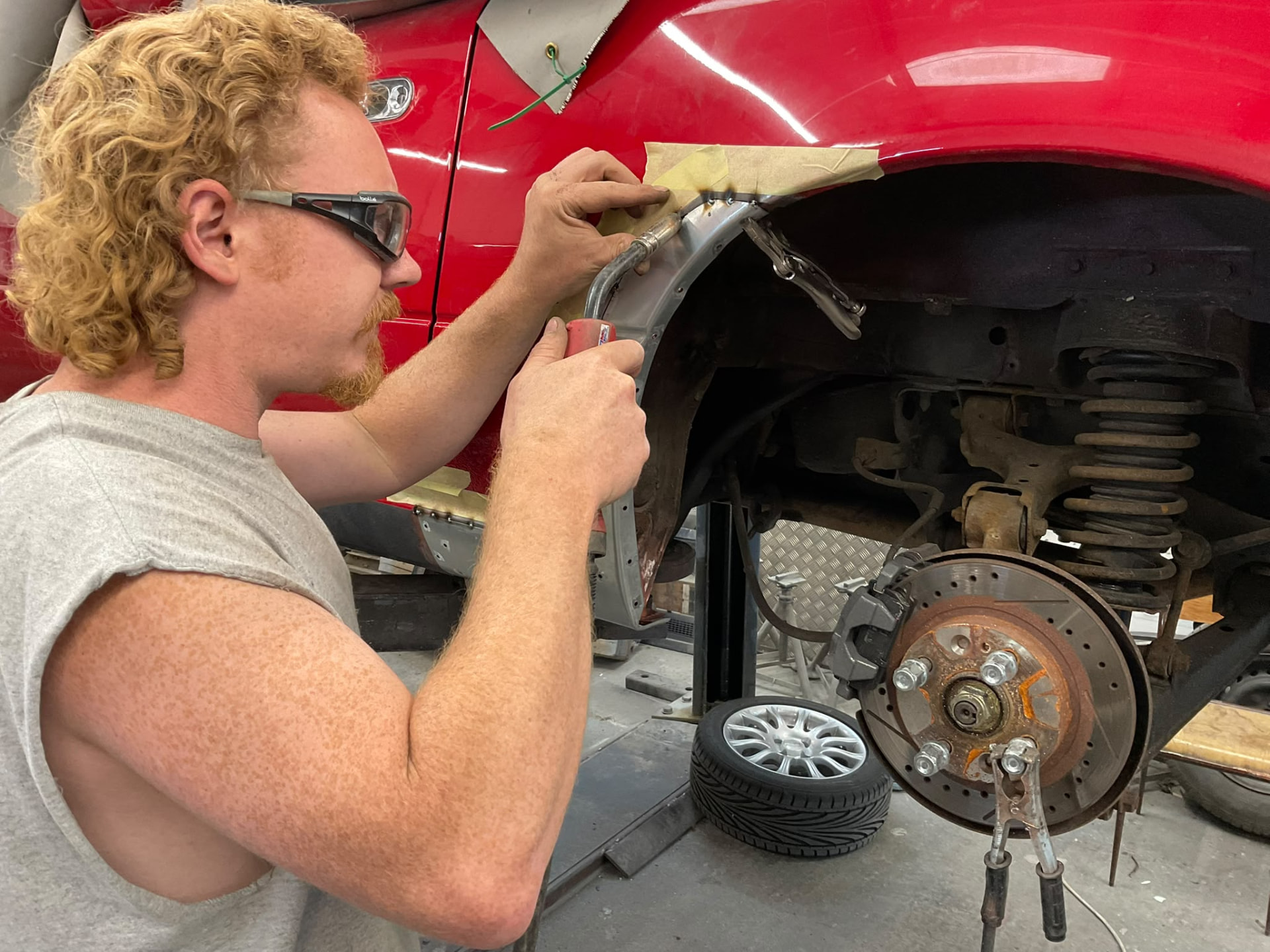 Welding a repair panel into a wheel arch at Albie's
